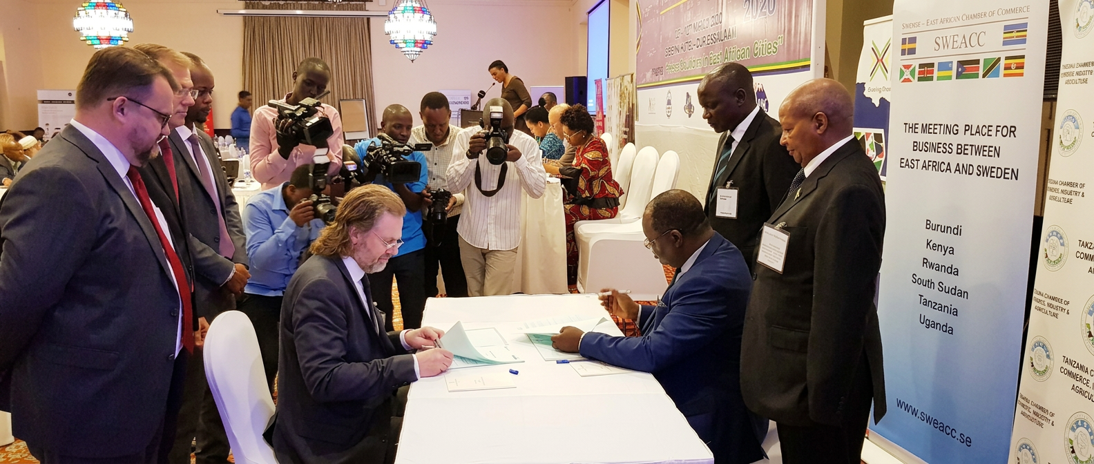 Swedish and East African representatives signing a partnership at a SWEACC gathering